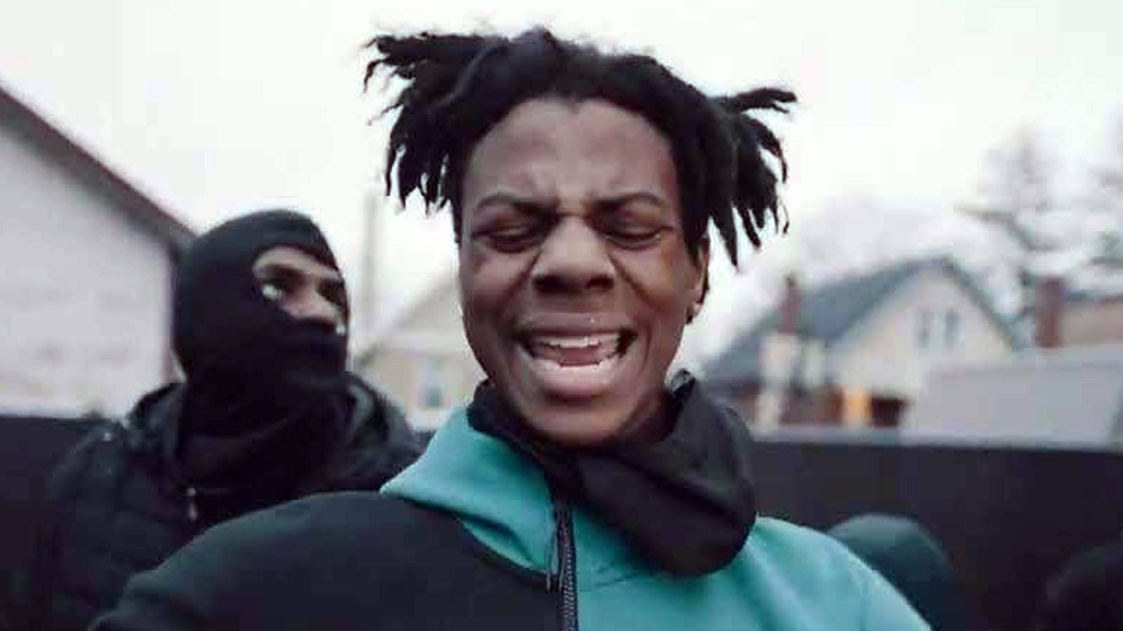 A Man With Dreadlocks Is Standing In Front Of A Group Of People Wallpaper