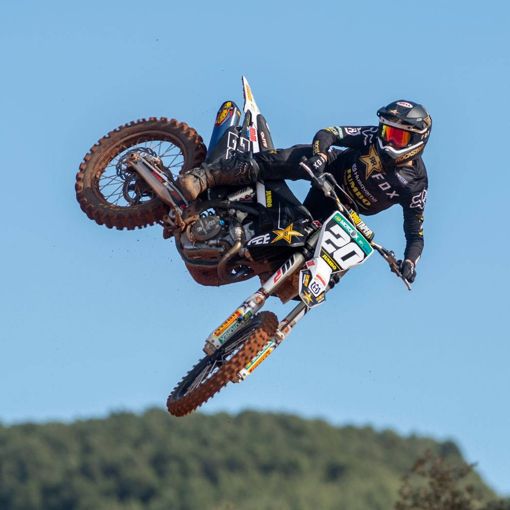 A Person Riding A Dirt Bike In The Air Wallpaper