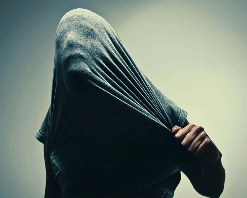 A Person With A Hood Covering Their Head Wallpaper