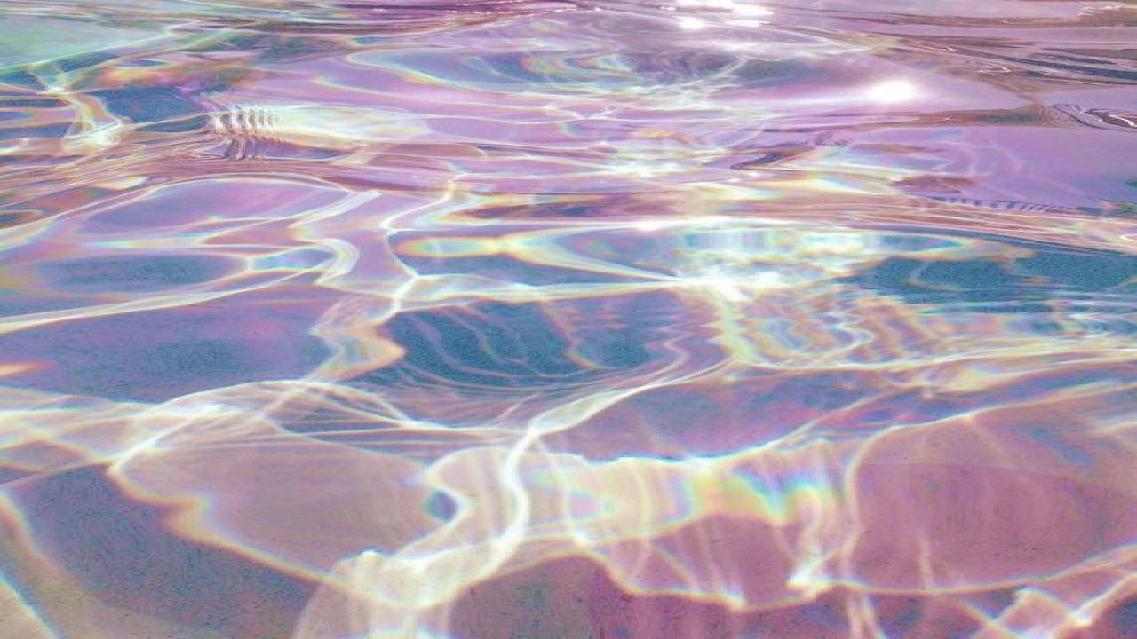 A Pool With A Rainbow Colored Water Wallpaper