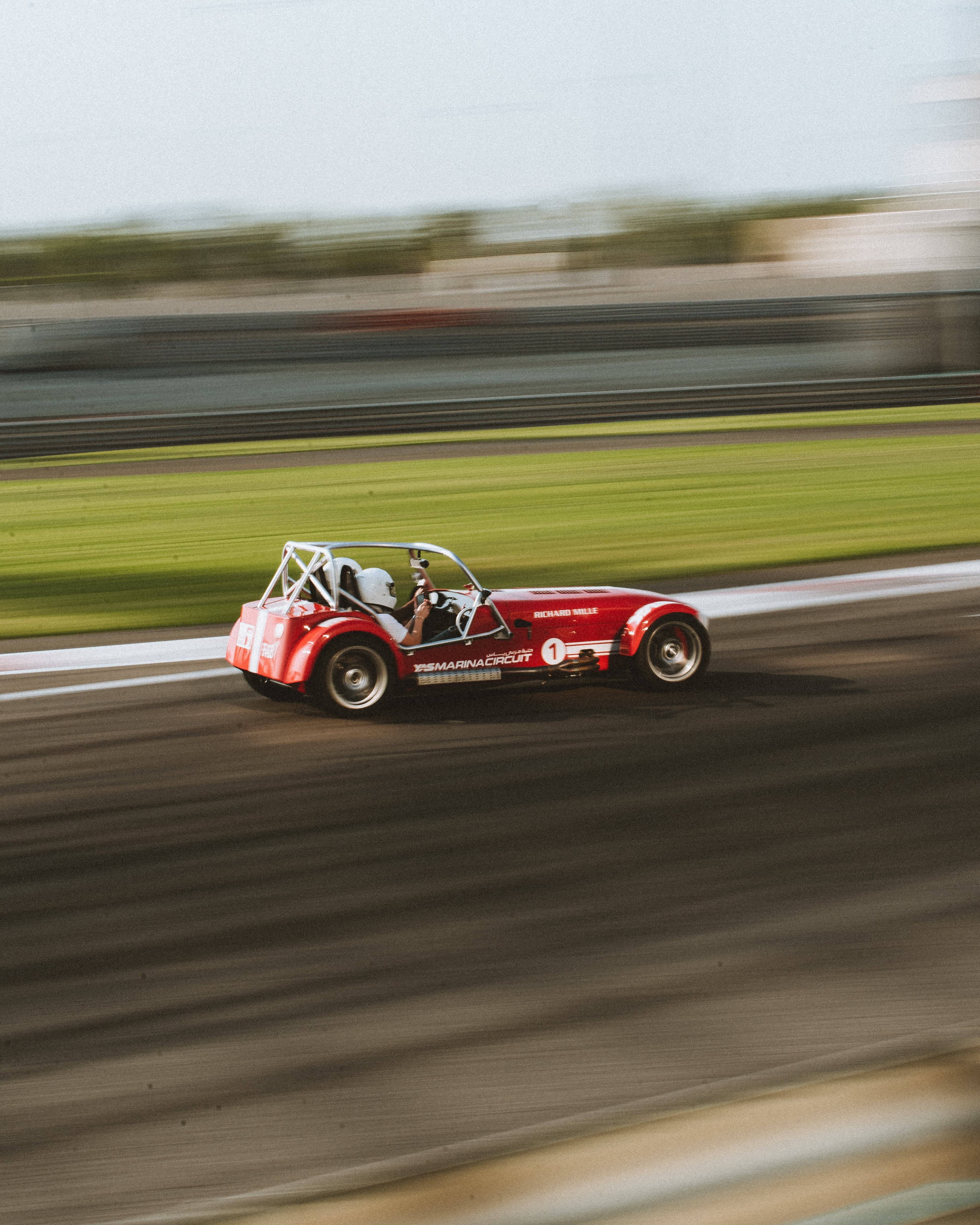 A Red Caterham Racecar At Maximum Speed Wallpaper