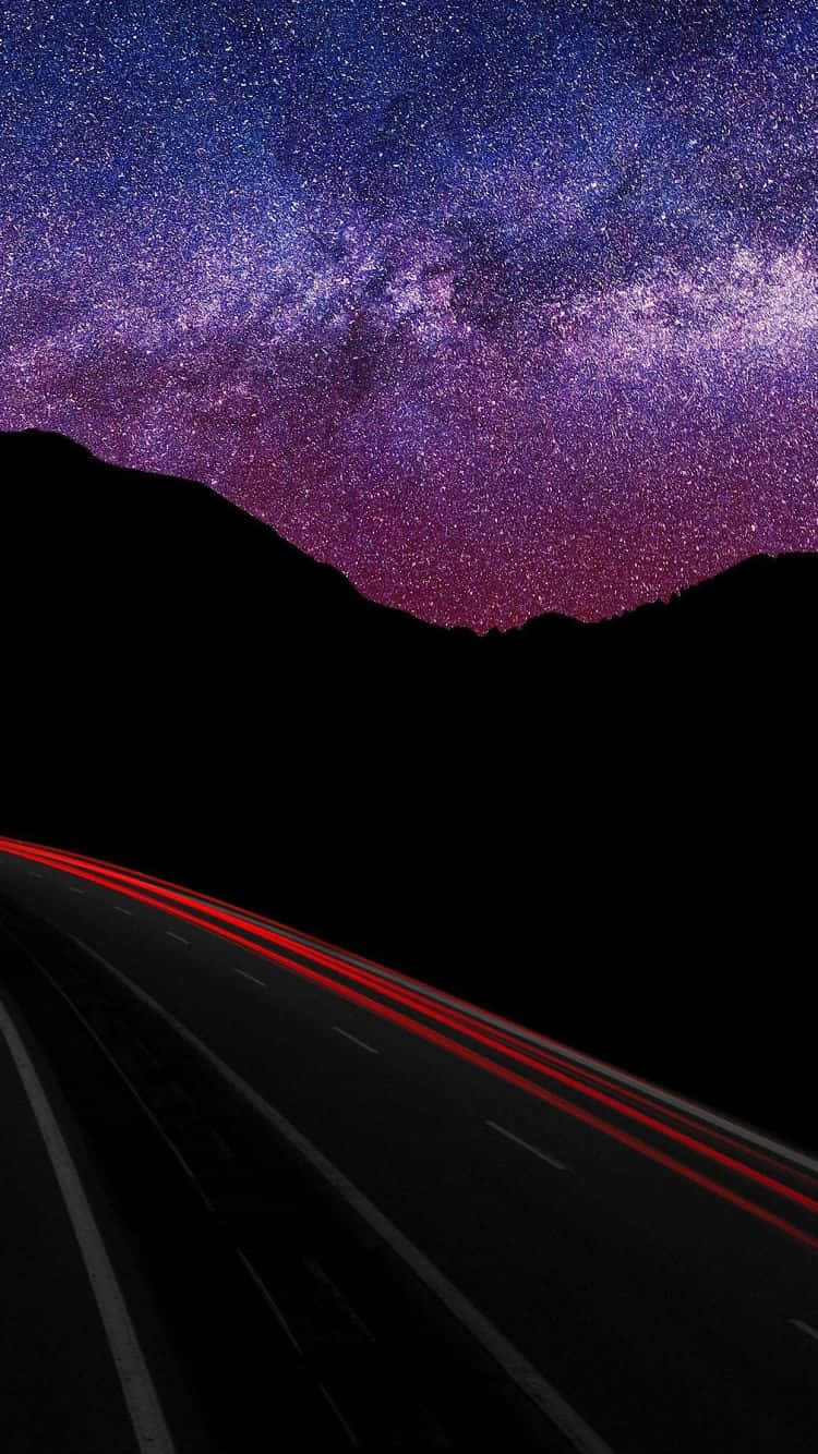A Road With Stars And Milky Lights In The Sky Wallpaper