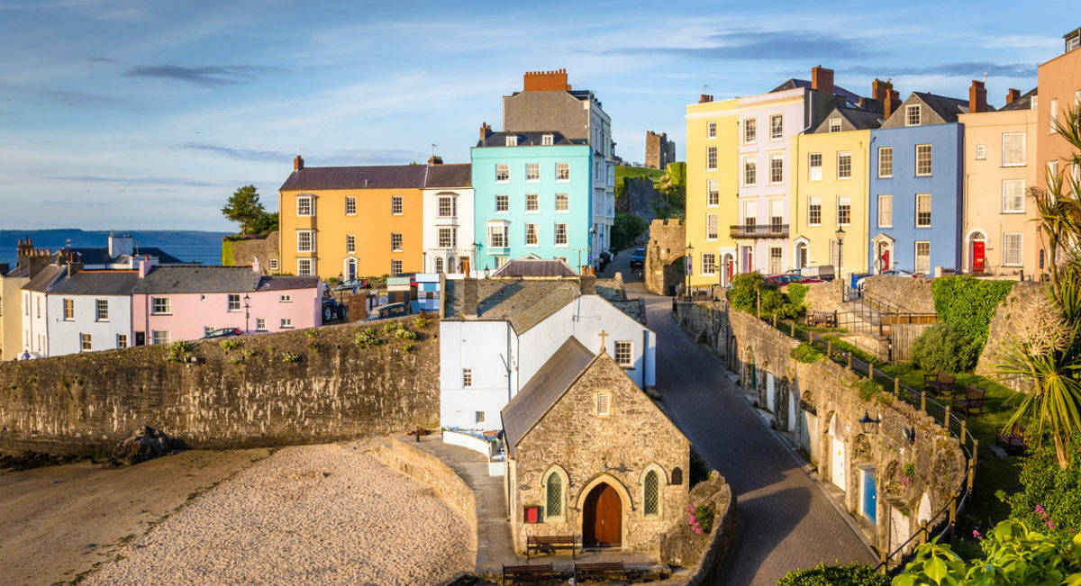 A Row Of Colorful Buildings On A Beach Wallpaper