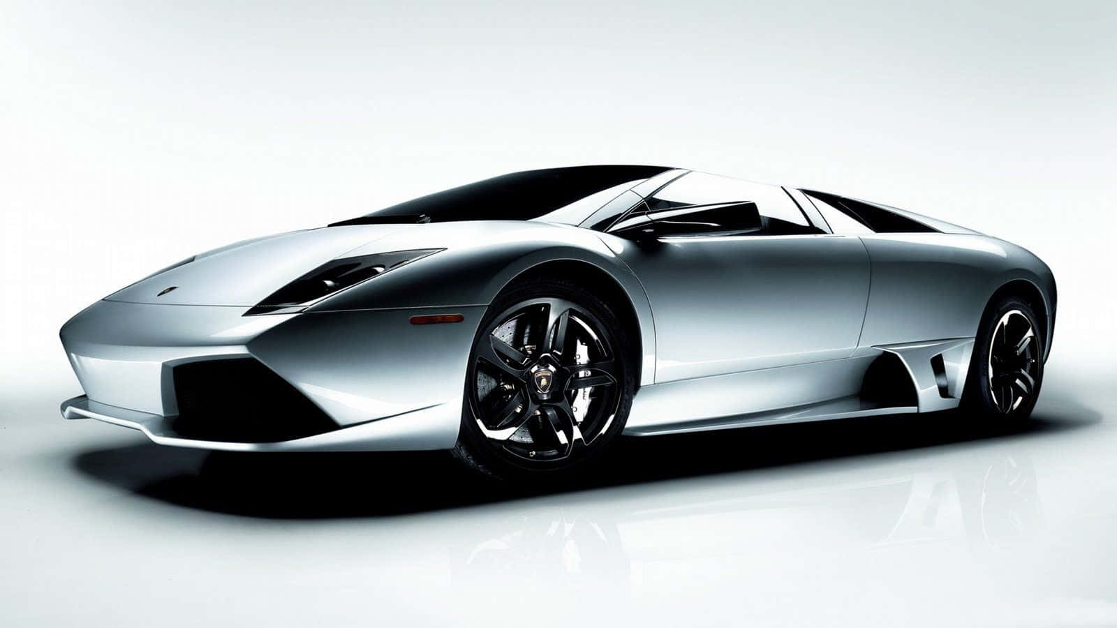 A Silver Sports Car Is Shown In A White Background Wallpaper