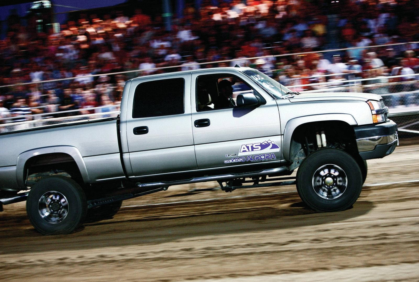 A Silver Truck Driving On Dirt Wallpaper