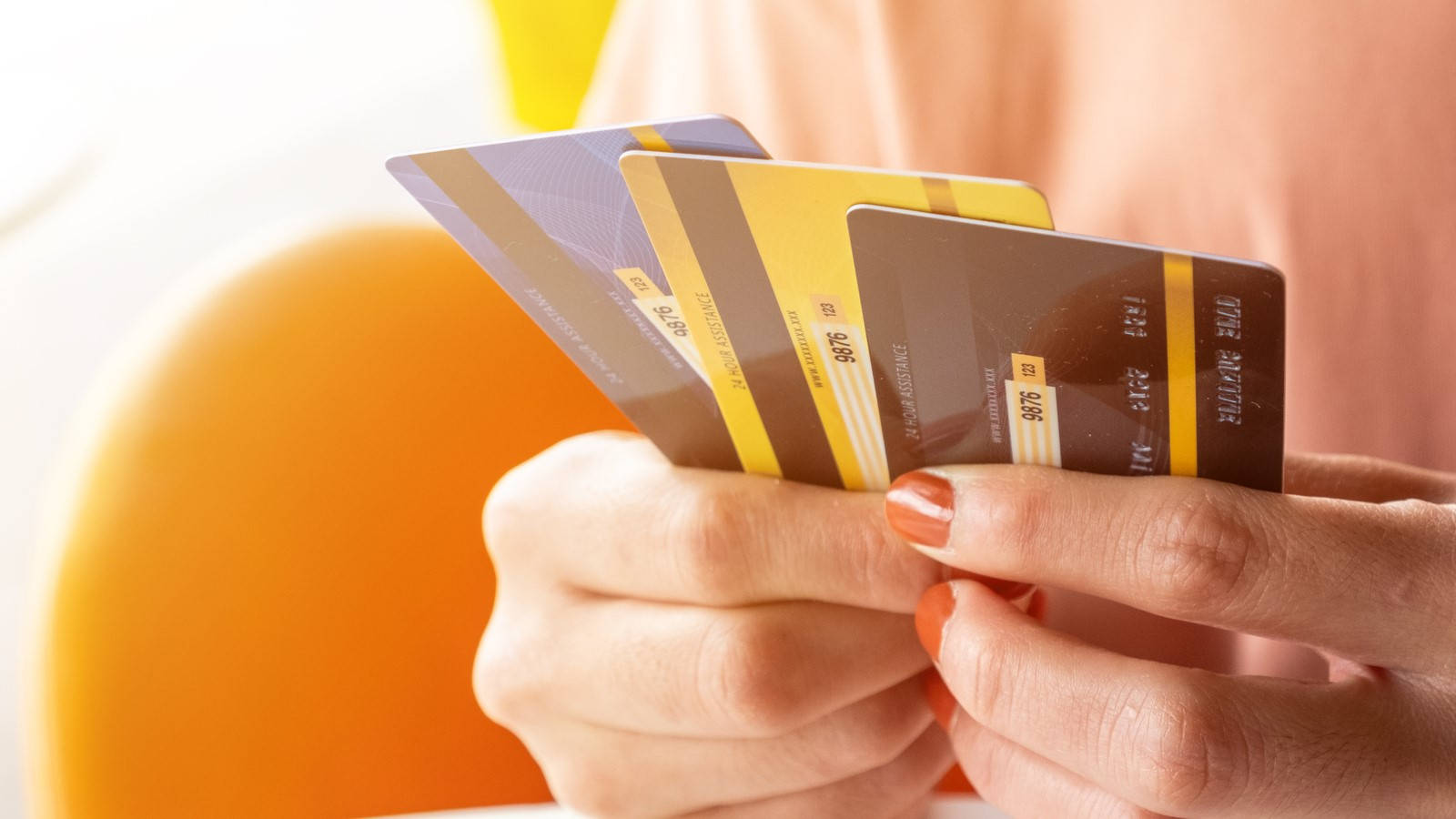 A Stack Of Blue, Yellow, And Black Credit Cards Wallpaper