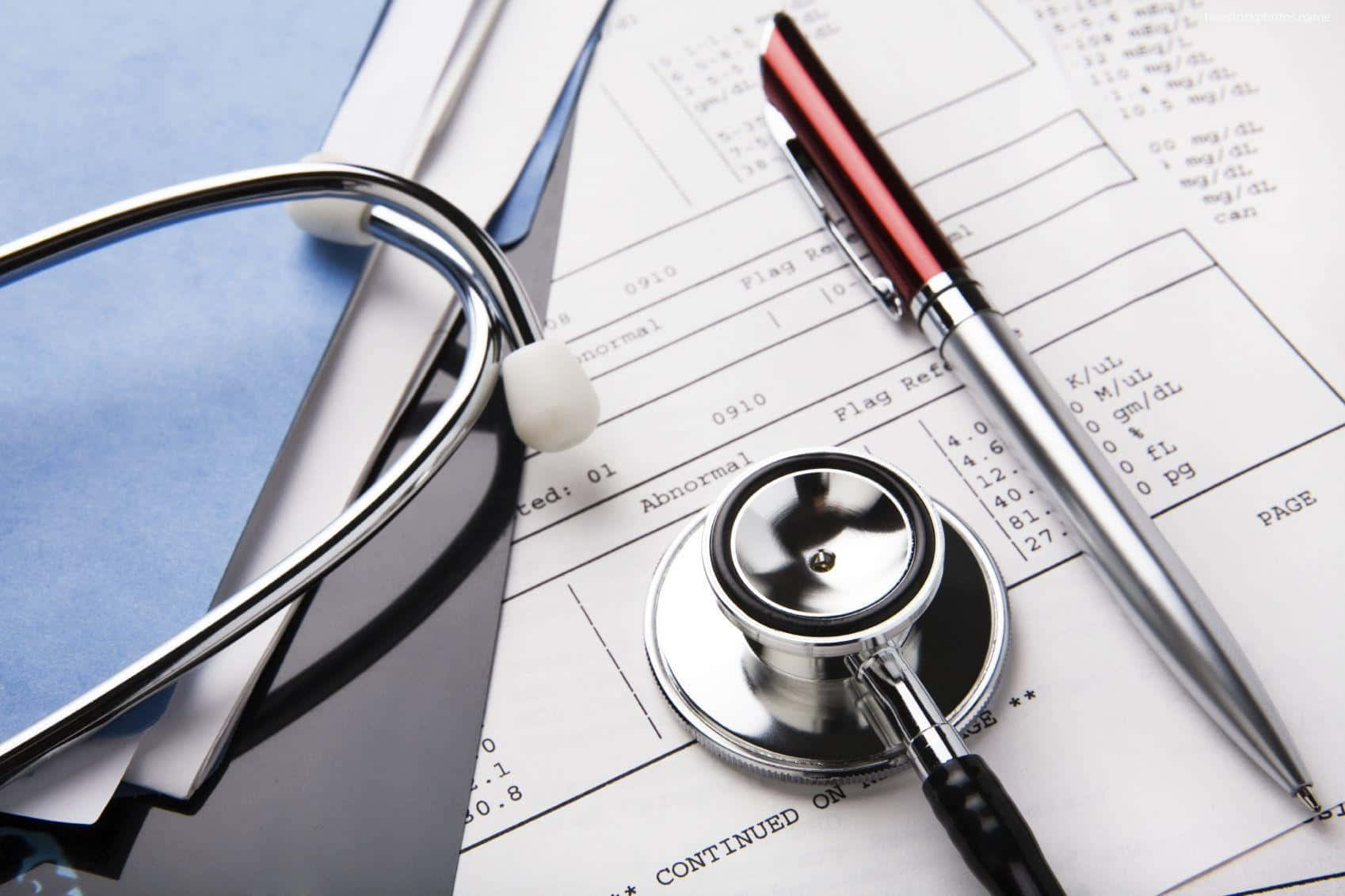 A Stethoscope And Pen On Top Of Medical Papers Wallpaper
