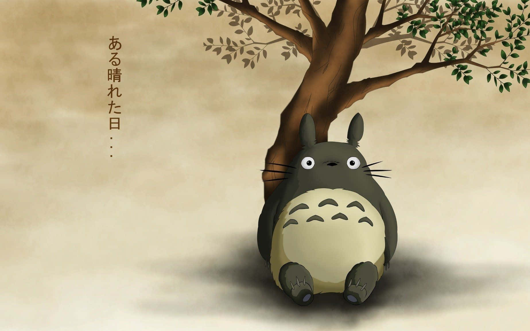 A Totoro Sitting Under A Tree Wallpaper