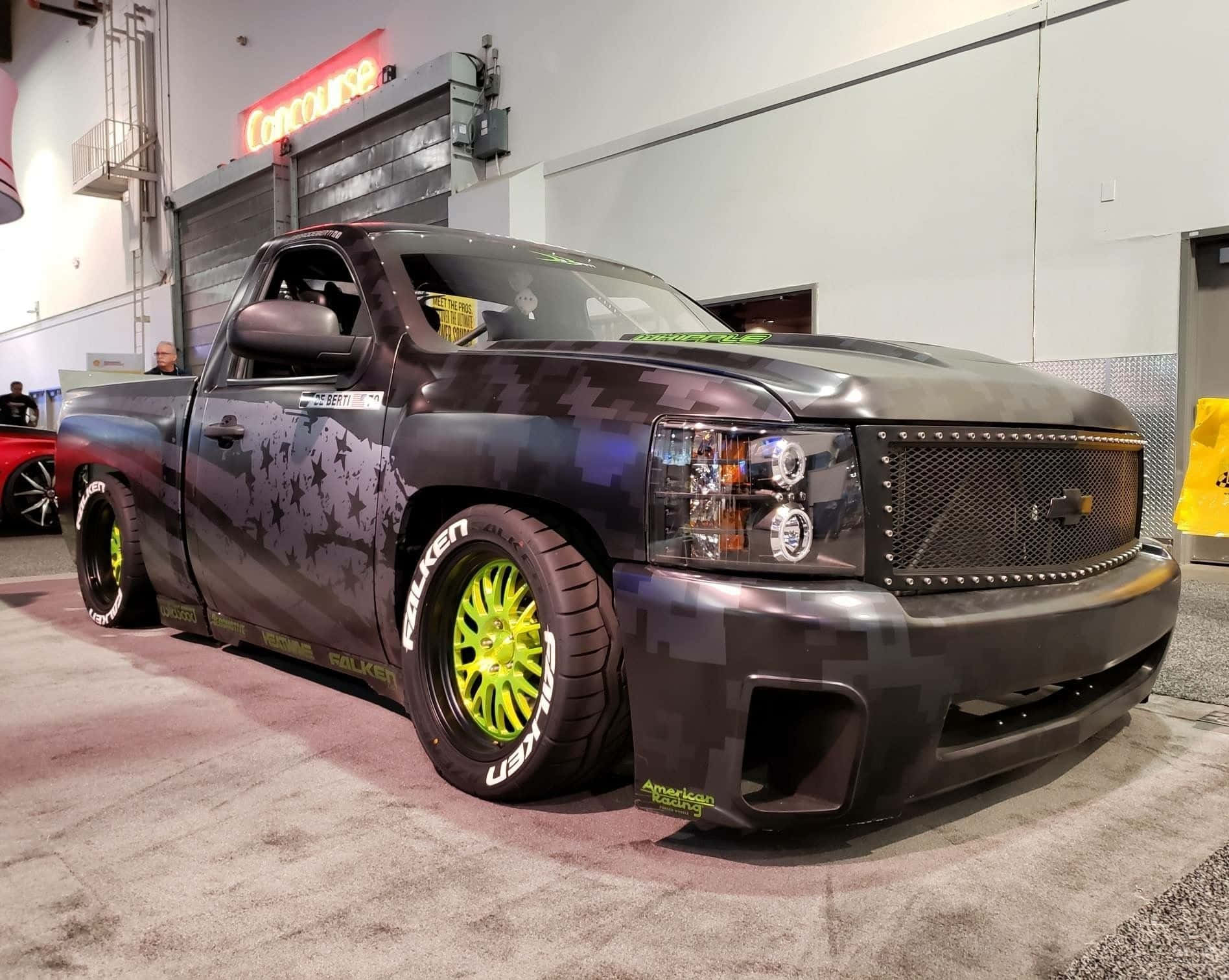 A Truck With A Black Paint Job And Yellow Wheels Wallpaper