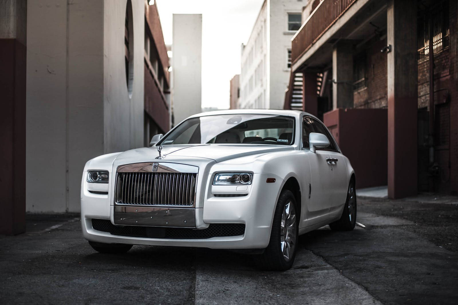 A Vision Of Prestige - White Ghost Luxury Car In An Alley Wallpaper