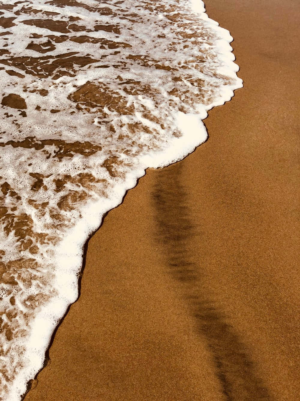 A Wave Is Coming Into The Beach Wallpaper