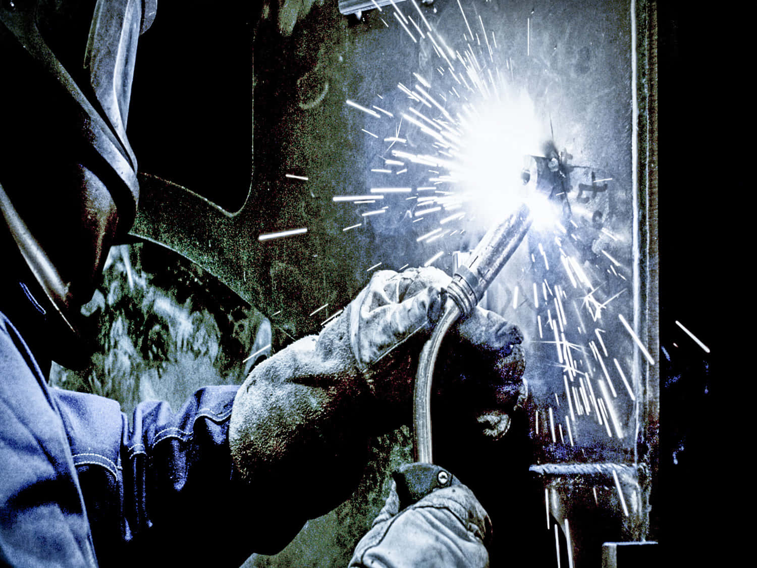 A Welder Is Welding In The Dark Wallpaper