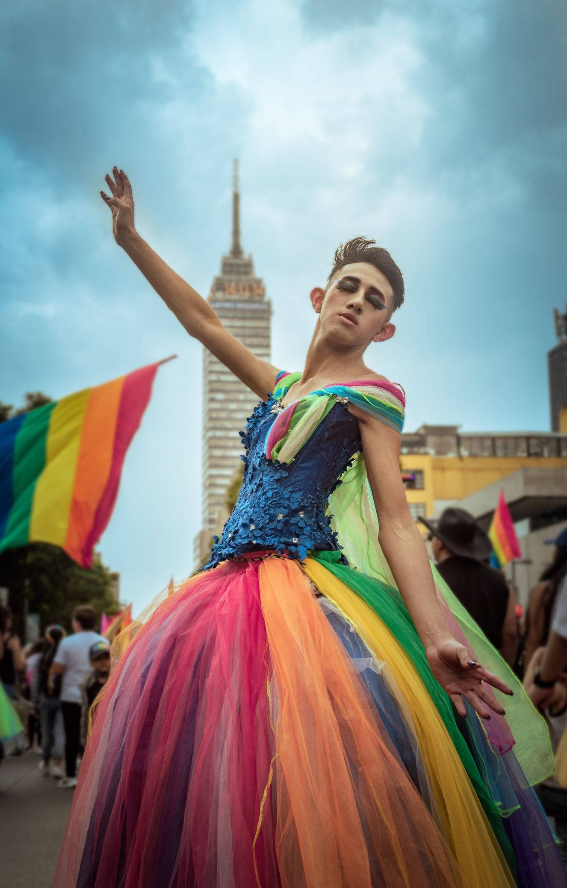 A Woman In A Rainbow Dress Is Holding A Flag Wallpaper