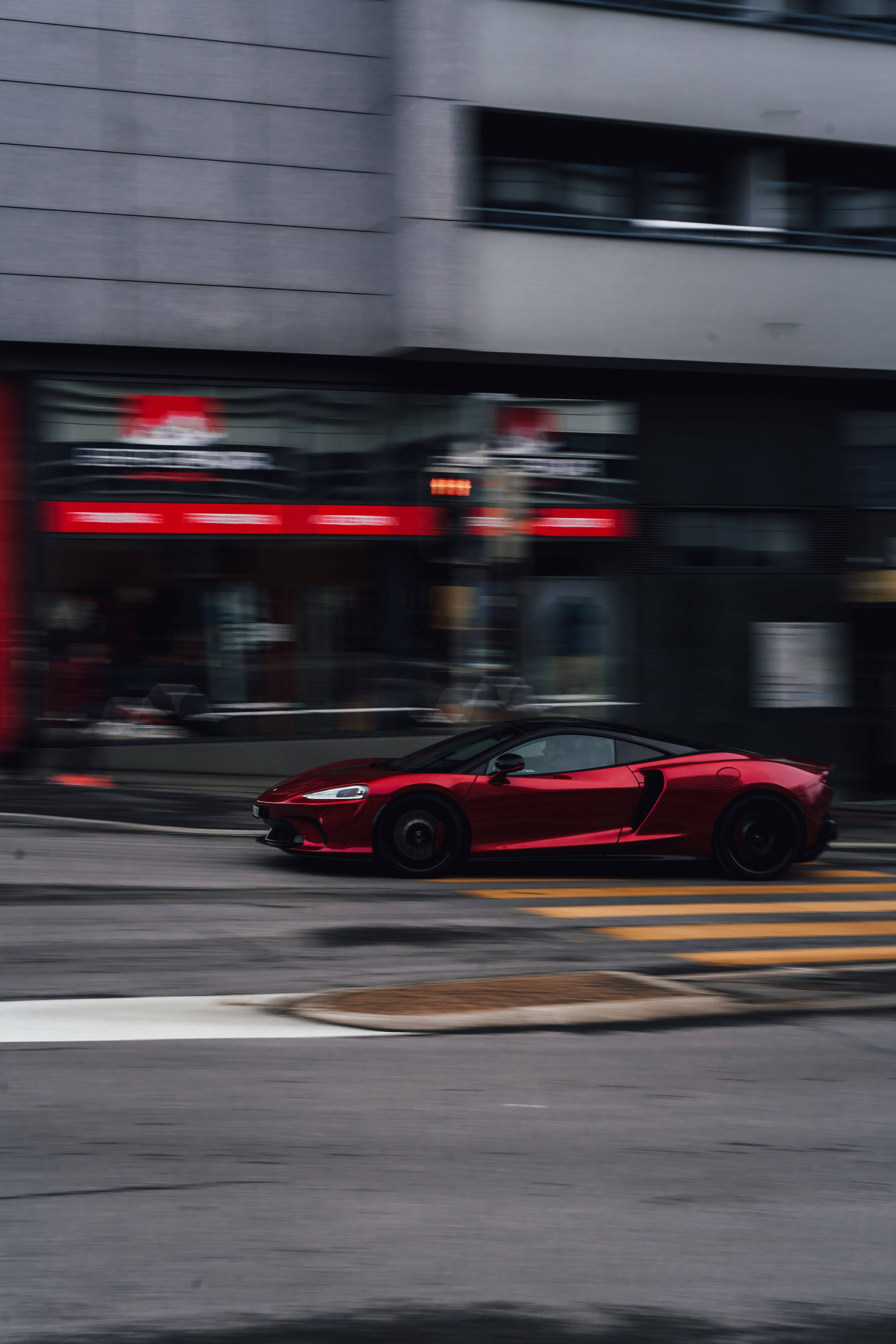 Accelerating Red And Black Sports Car Wallpaper