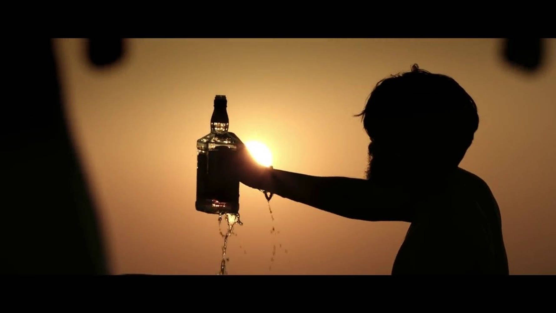Adithya Varma Contemplation Scene With A Drink Wallpaper