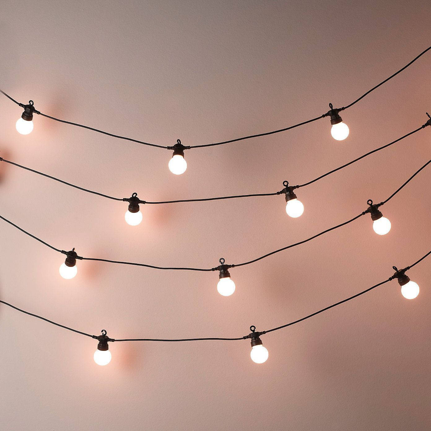 Aesthetic Fairy Lights In White Wall Wallpaper