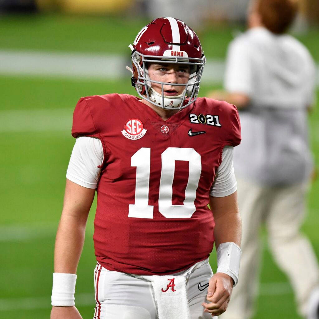 Alabama Football Player In Uniform Walking On The Field Wallpaper