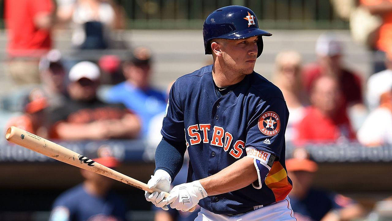 Alex Bregman Holding Bat In Dark Blue Uniform Wallpaper