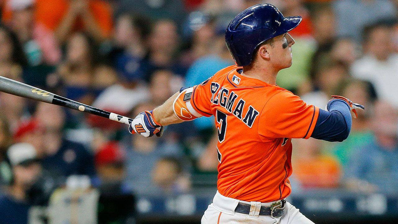 Alex Bregman In Orange Astros Uniform Swinging Bat Wallpaper