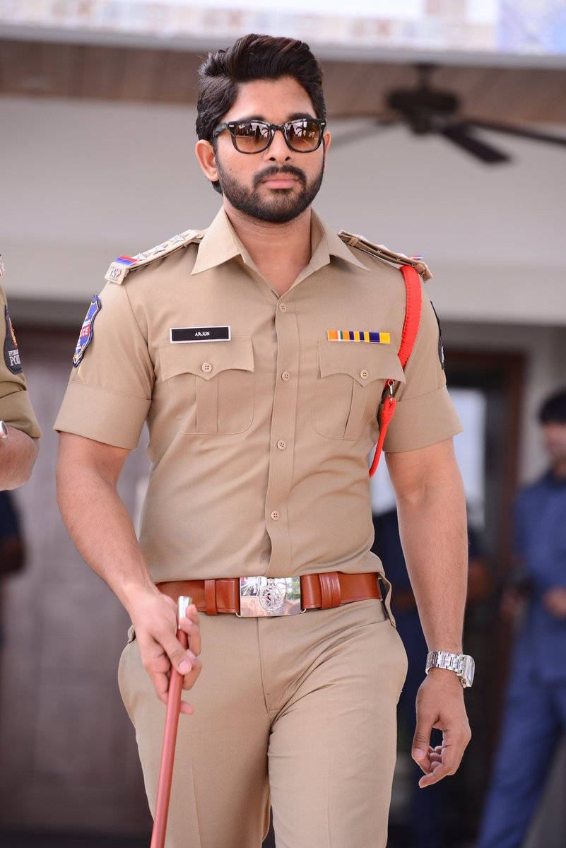 Allu Arjun In Police Uniform Holding Cane Wallpaper
