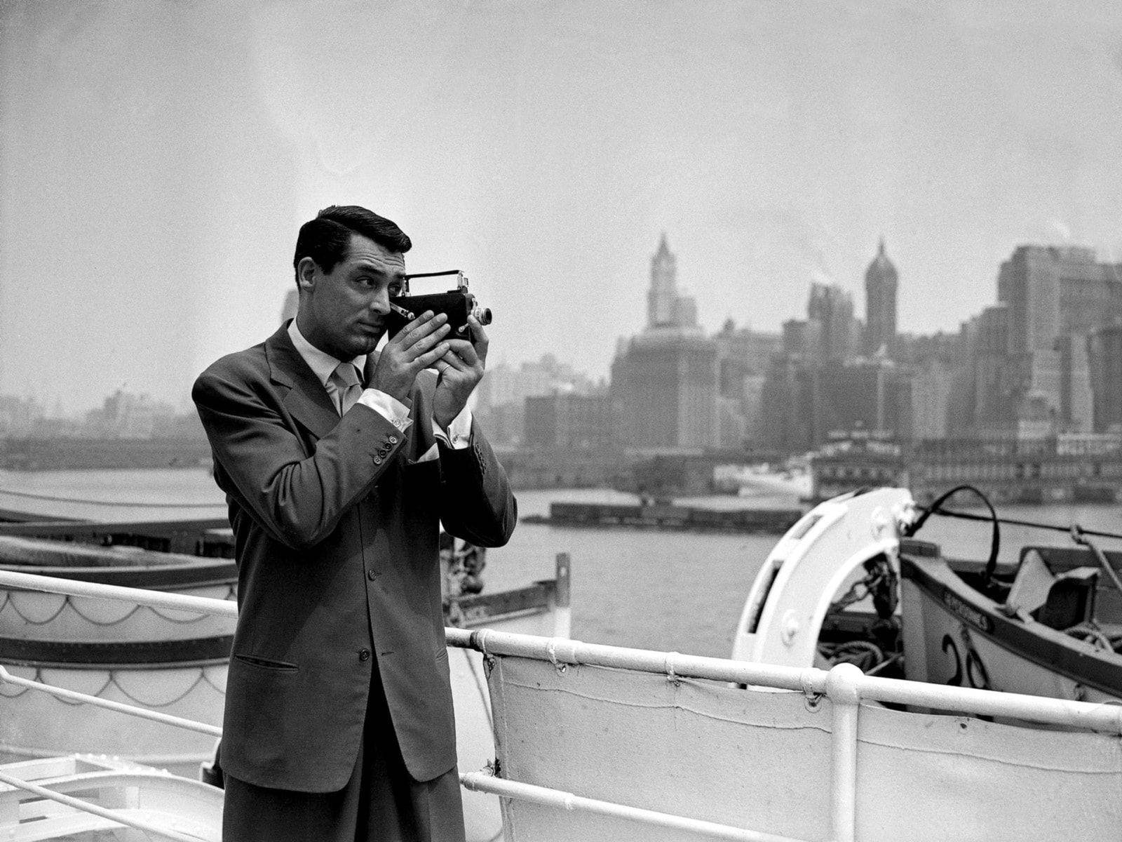 American Actor Cary Grant With A Camera Wallpaper