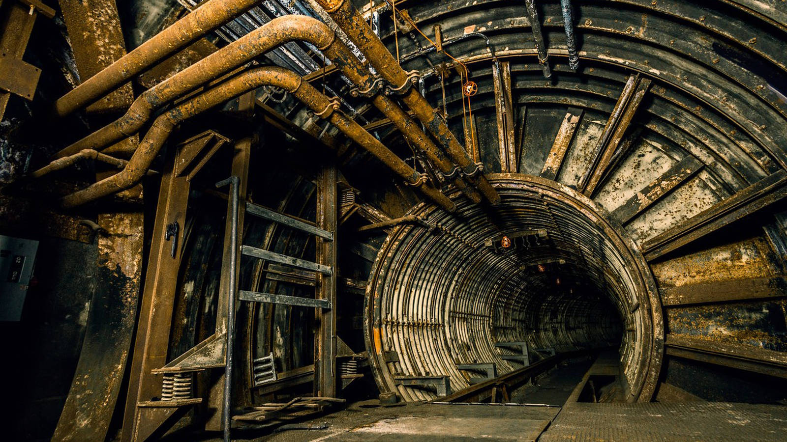 An Extensive Industrial Pipeline In Underground Tunnel Wallpaper