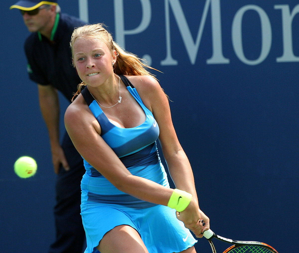 Anett Kontaveit In Blue Hitting Ball Wallpaper