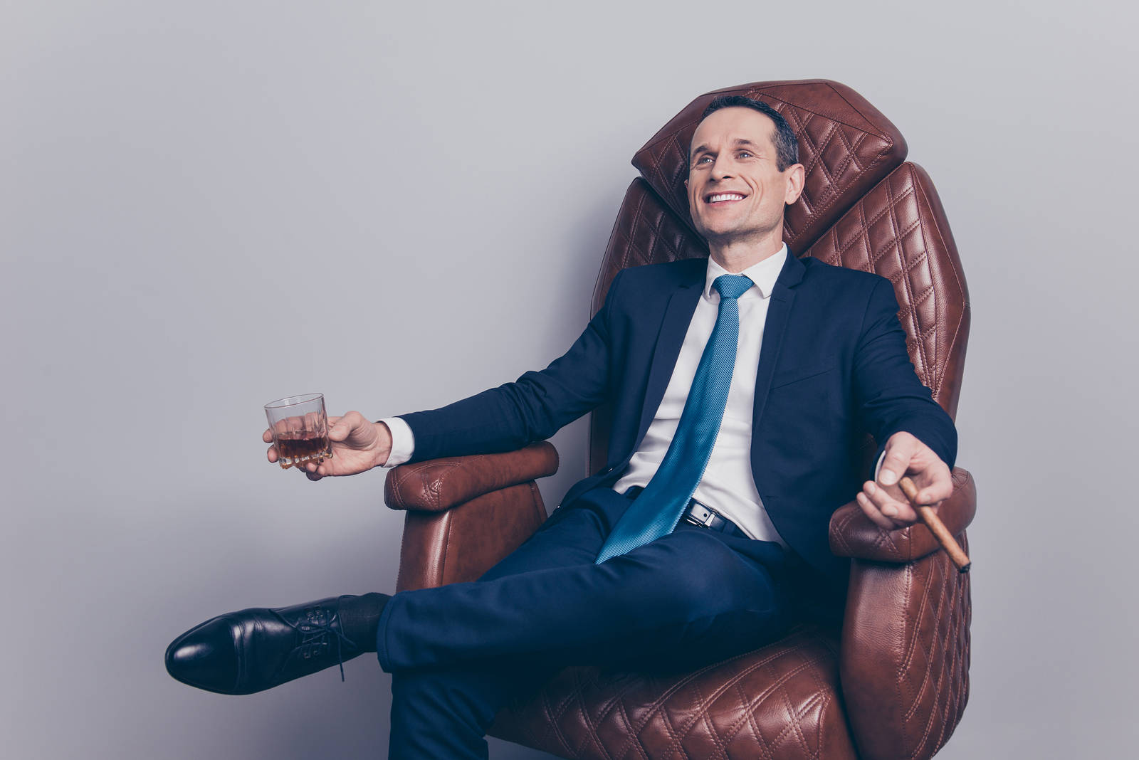 Arrogant Businessman Sitting On Leather Chair Wallpaper
