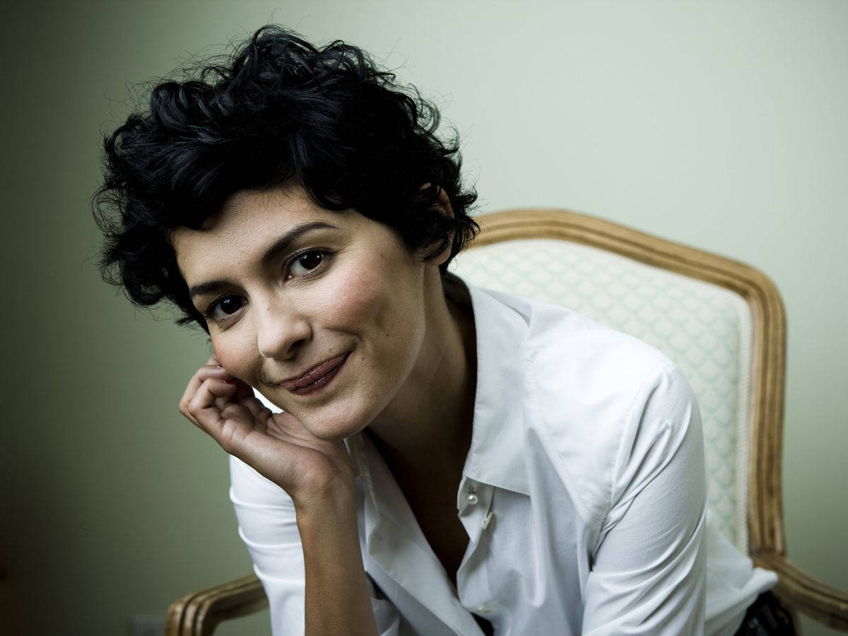 Audrey Tatou Sitting On White Chair Wallpaper