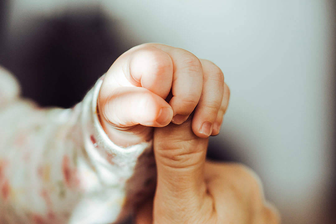 Baby Boy Holding A Thumb Wallpaper