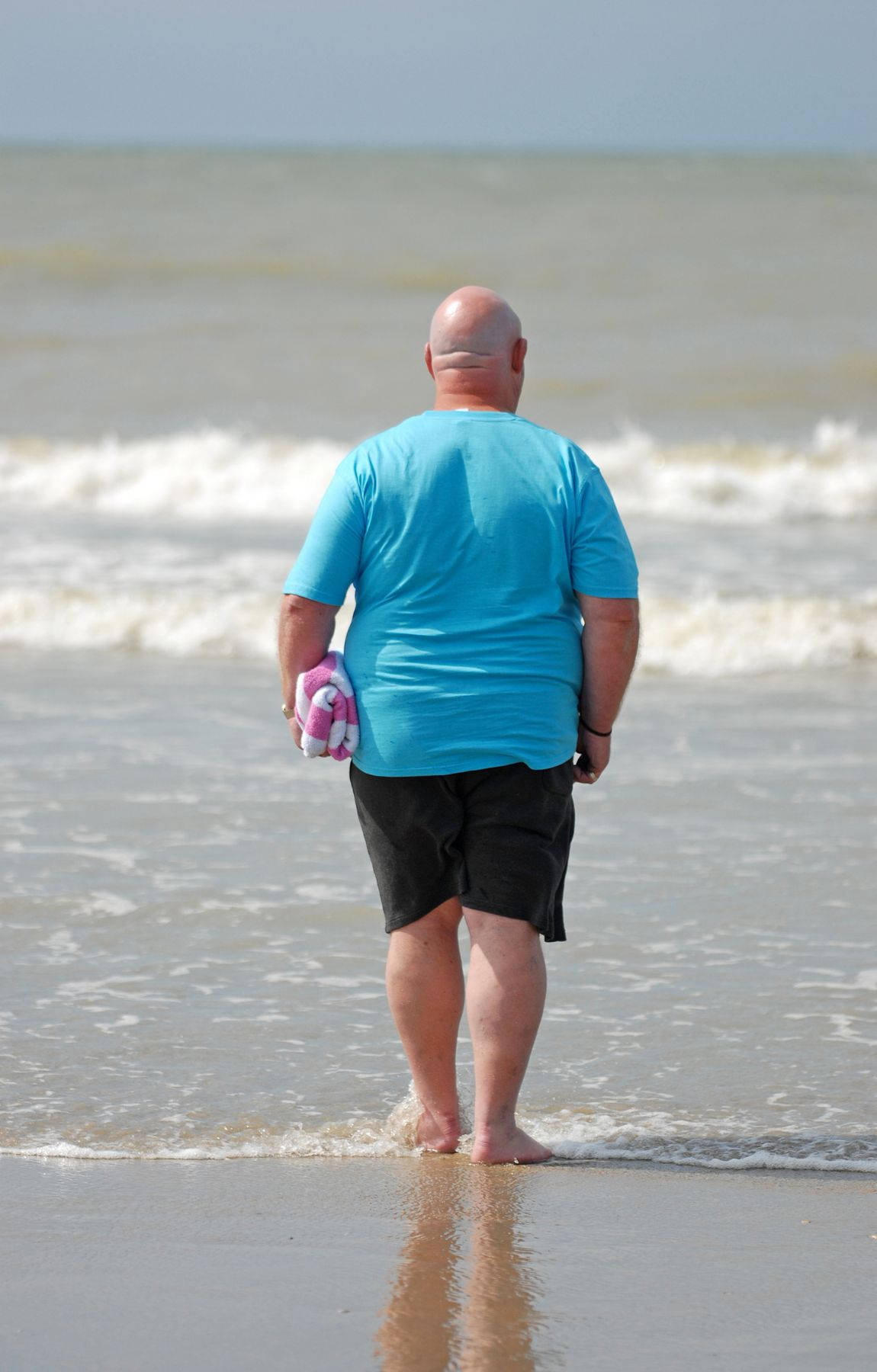 Bald Man Walking On The Beach Wallpaper