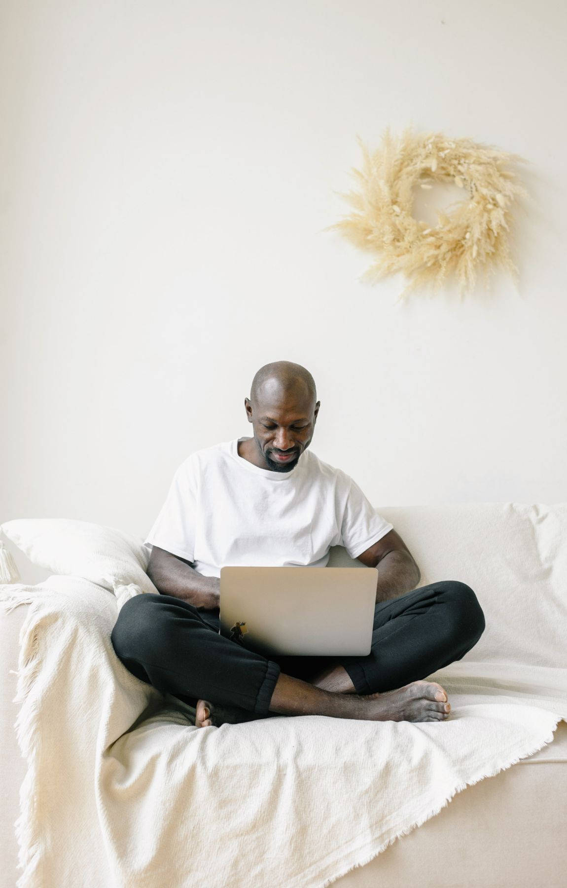 Bald Man Working On A Laptop Wallpaper