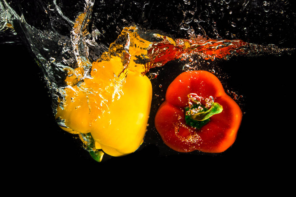 Bell Pepper Fruits Splashing Into Water Wallpaper