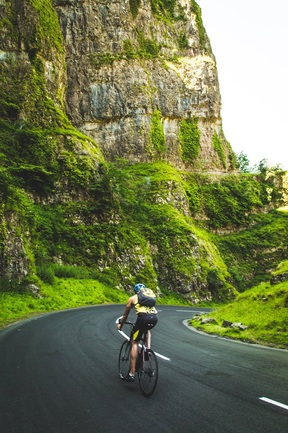Bike Lover Riding By The Mountain Side Wallpaper