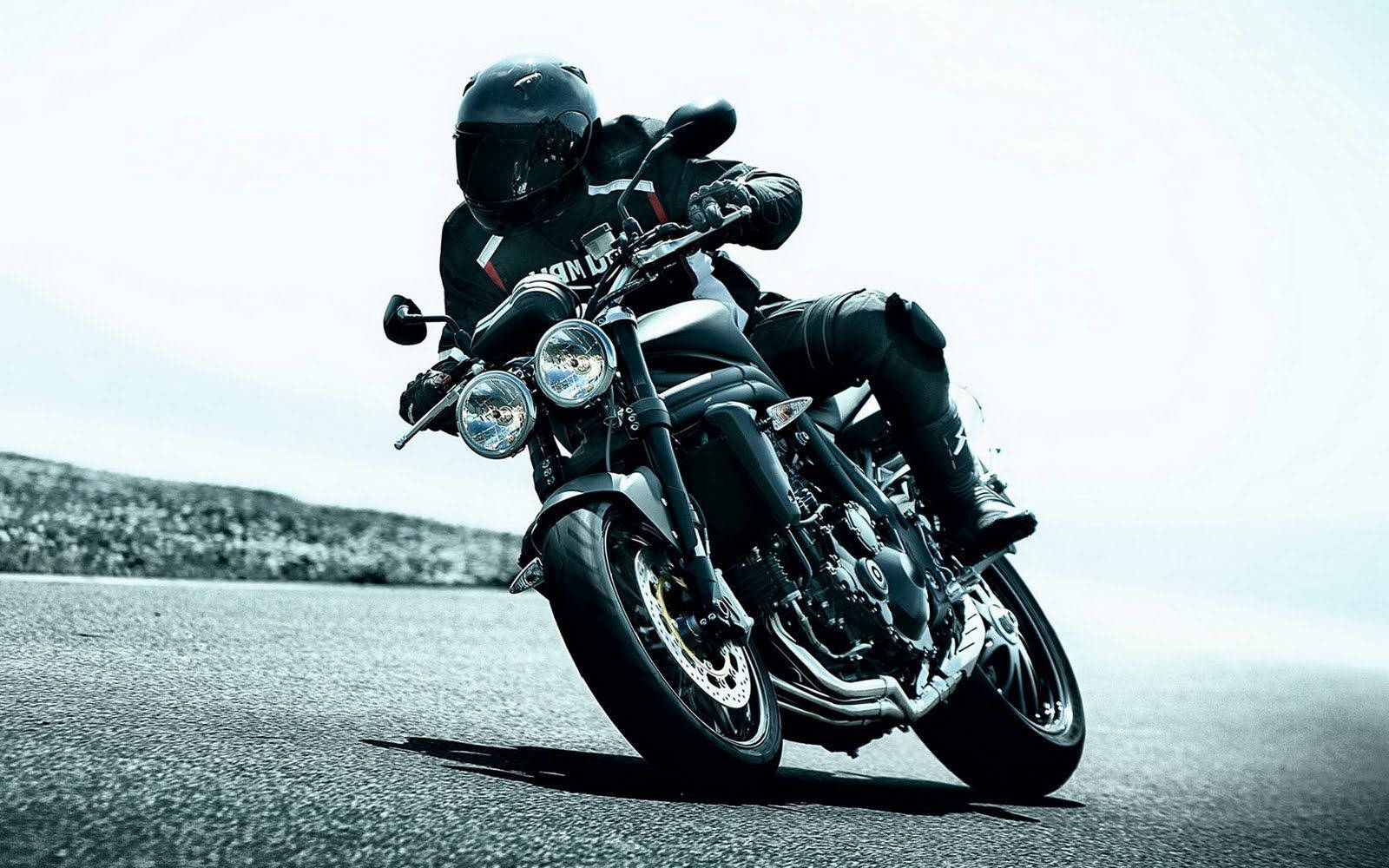 Black Motorcycle In Cornering Mode Wallpaper