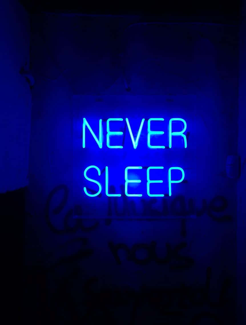 Blue Neon Never Sleep Sign Wallpaper