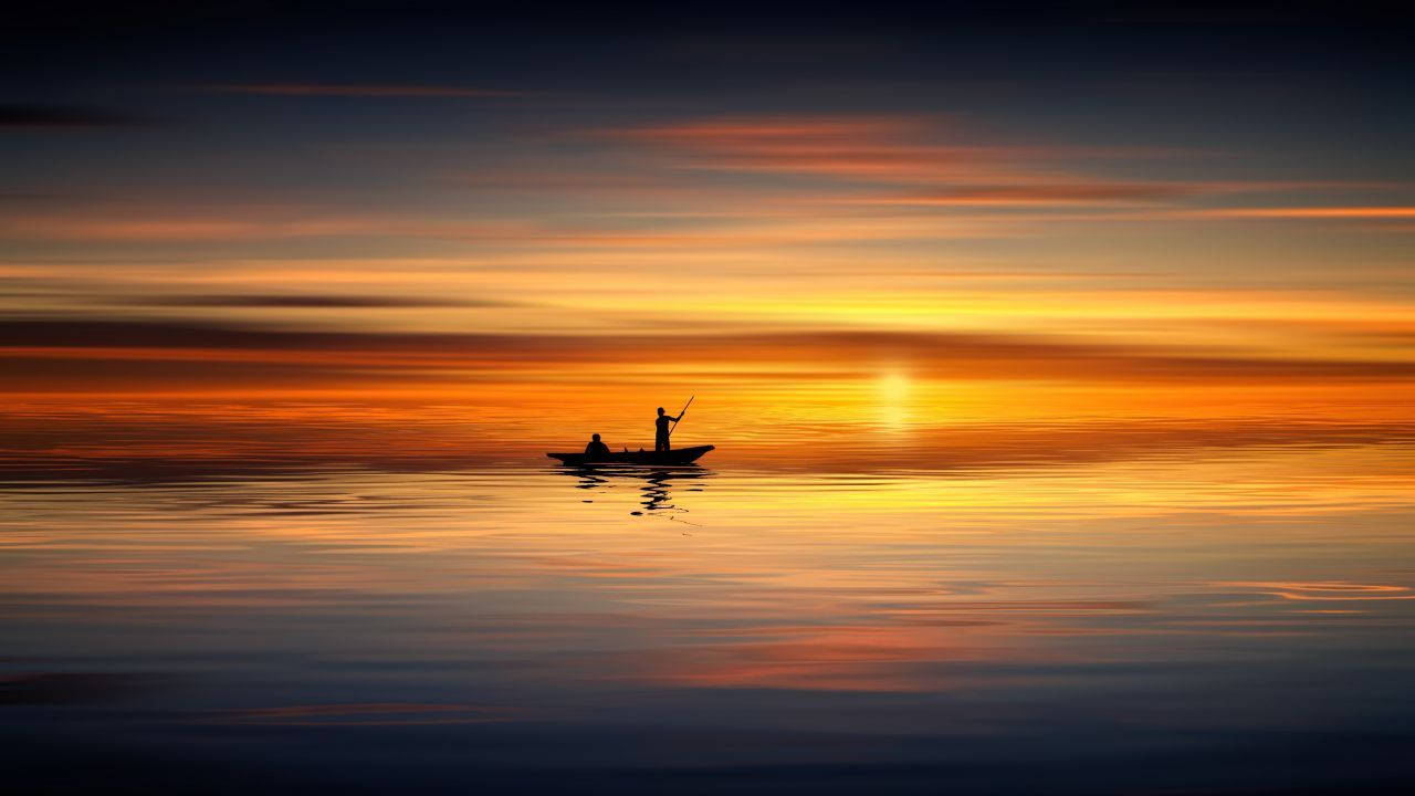 Boat Silhouette At Ocean Sunset Wallpaper