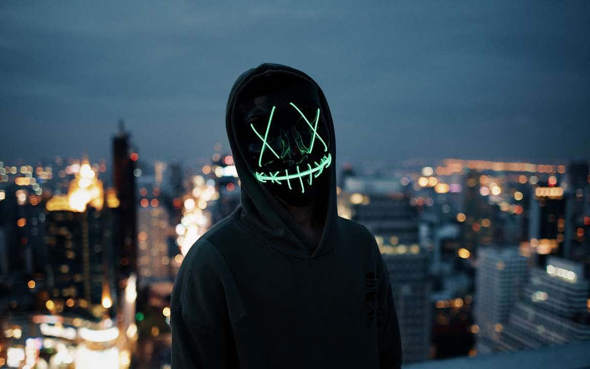 Boy With 4k Mask Overlooking City Lights Wallpaper