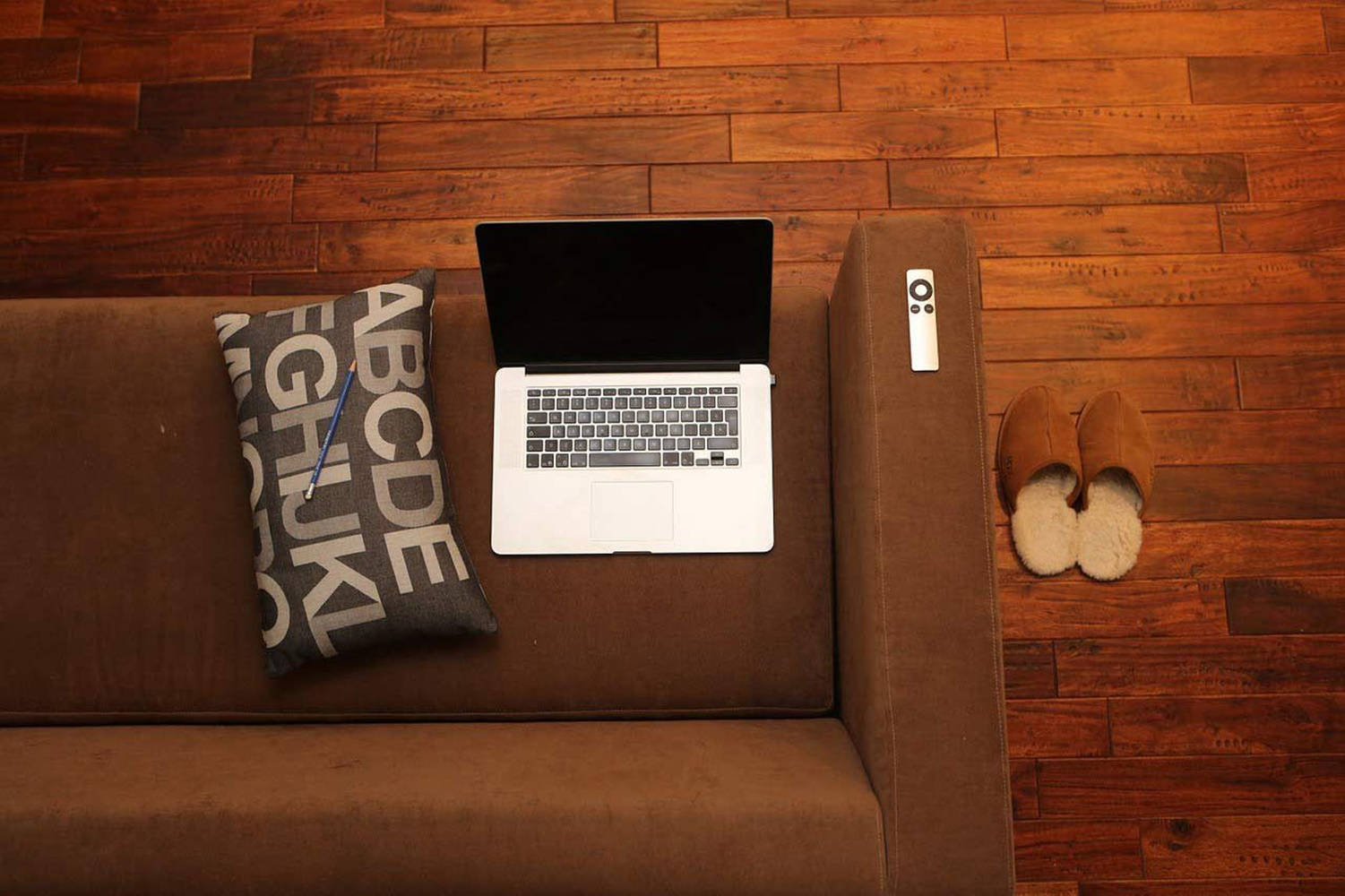Brown Aesthetic Couch With Laptop Wallpaper