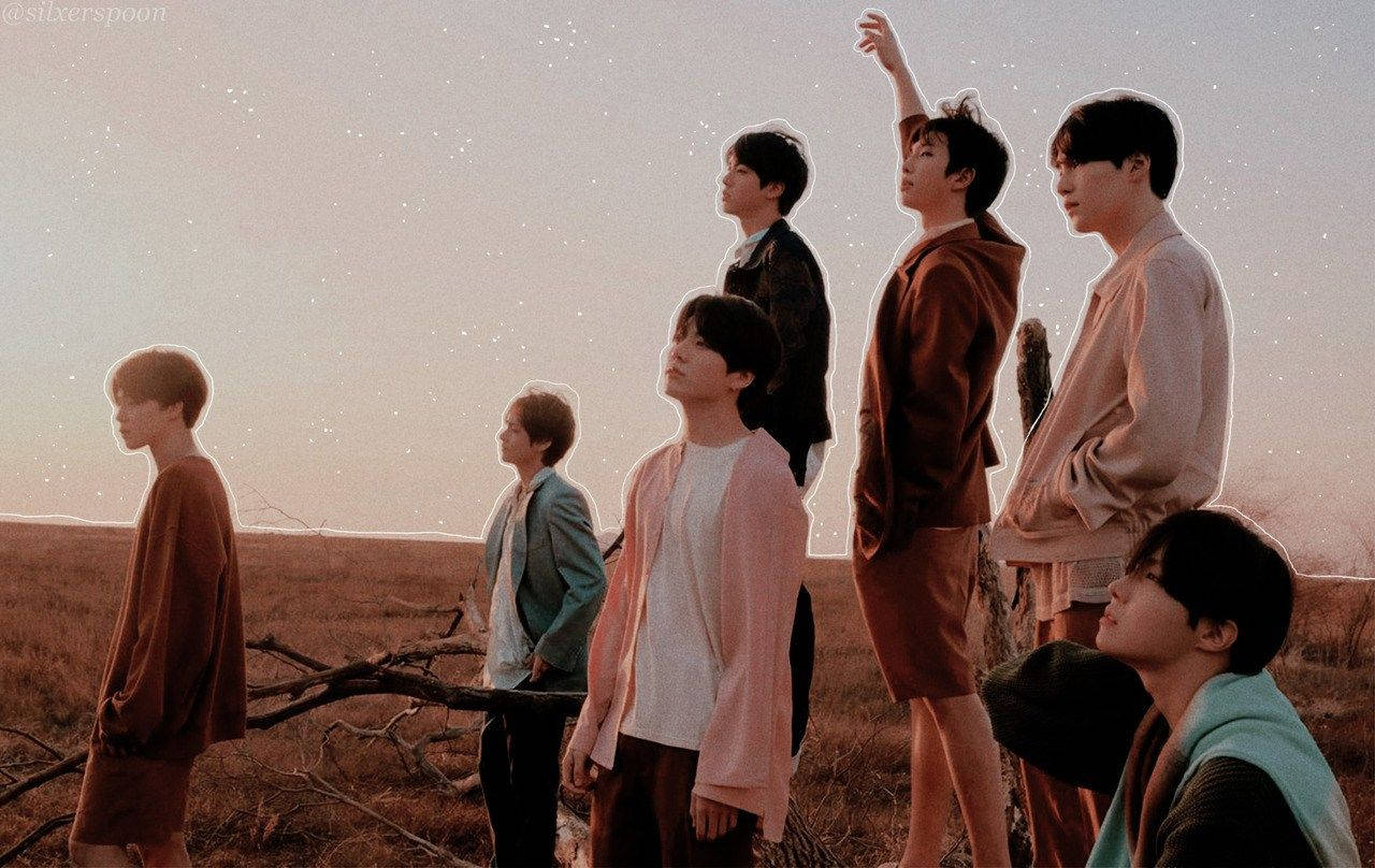 Bts Members On Field At Sunset Laptop Wallpaper