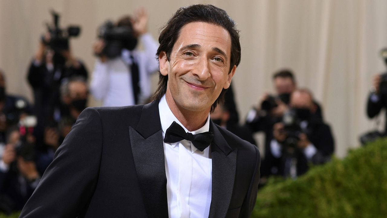 Caption: Adrien Brody Flashing A Charming Smile In Formal Wear Wallpaper