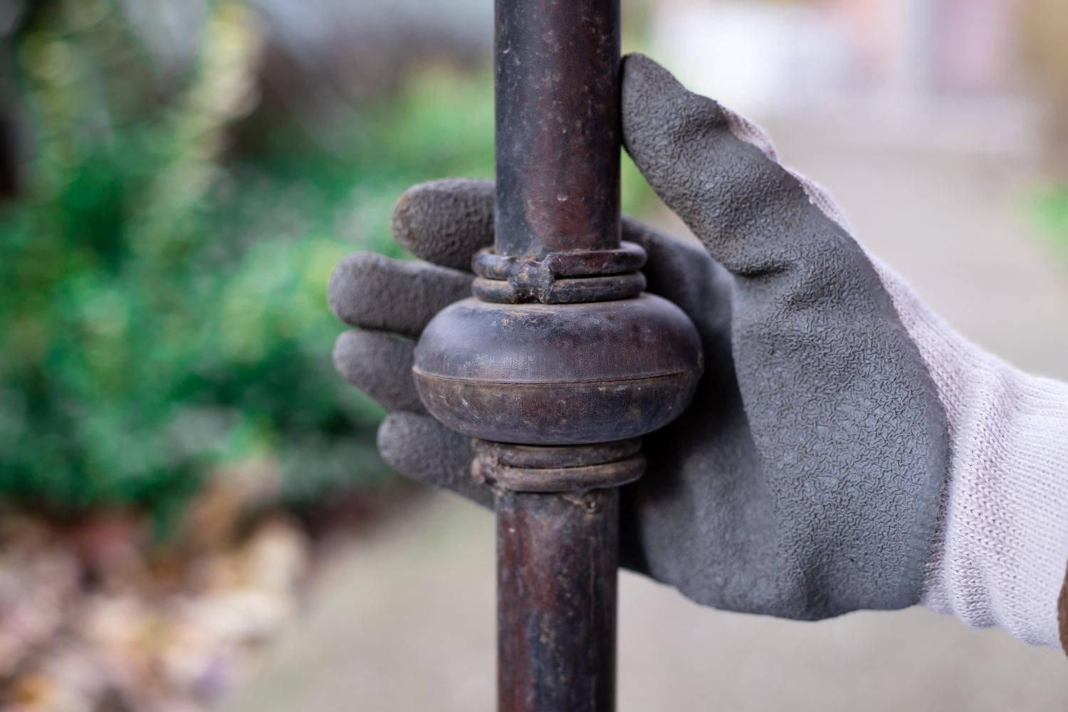 Caption: Artist's Hand Touching A Rustic Iron Surface Wallpaper