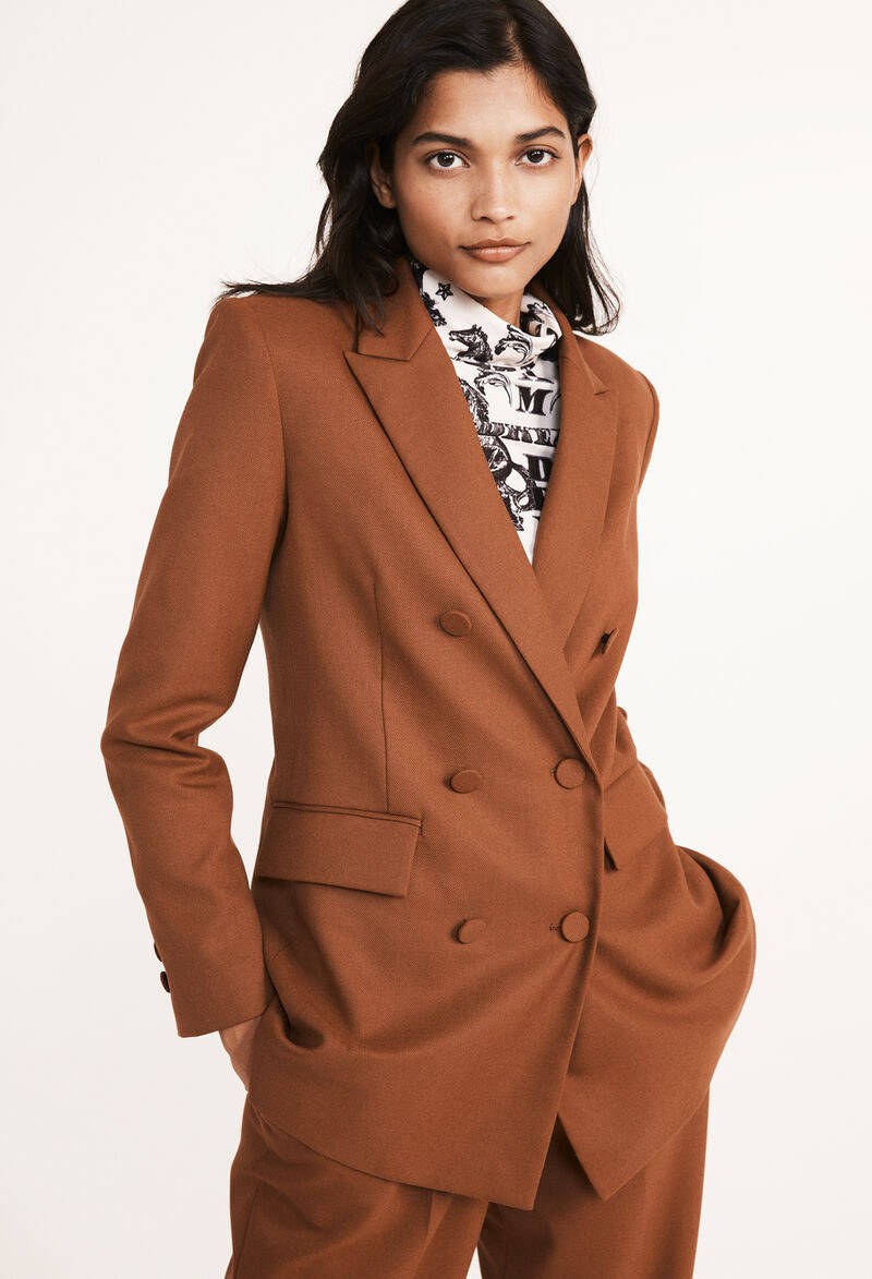 Caption: Elegance Personified By Claudie Pierlot Brown Formal Blazer Wallpaper