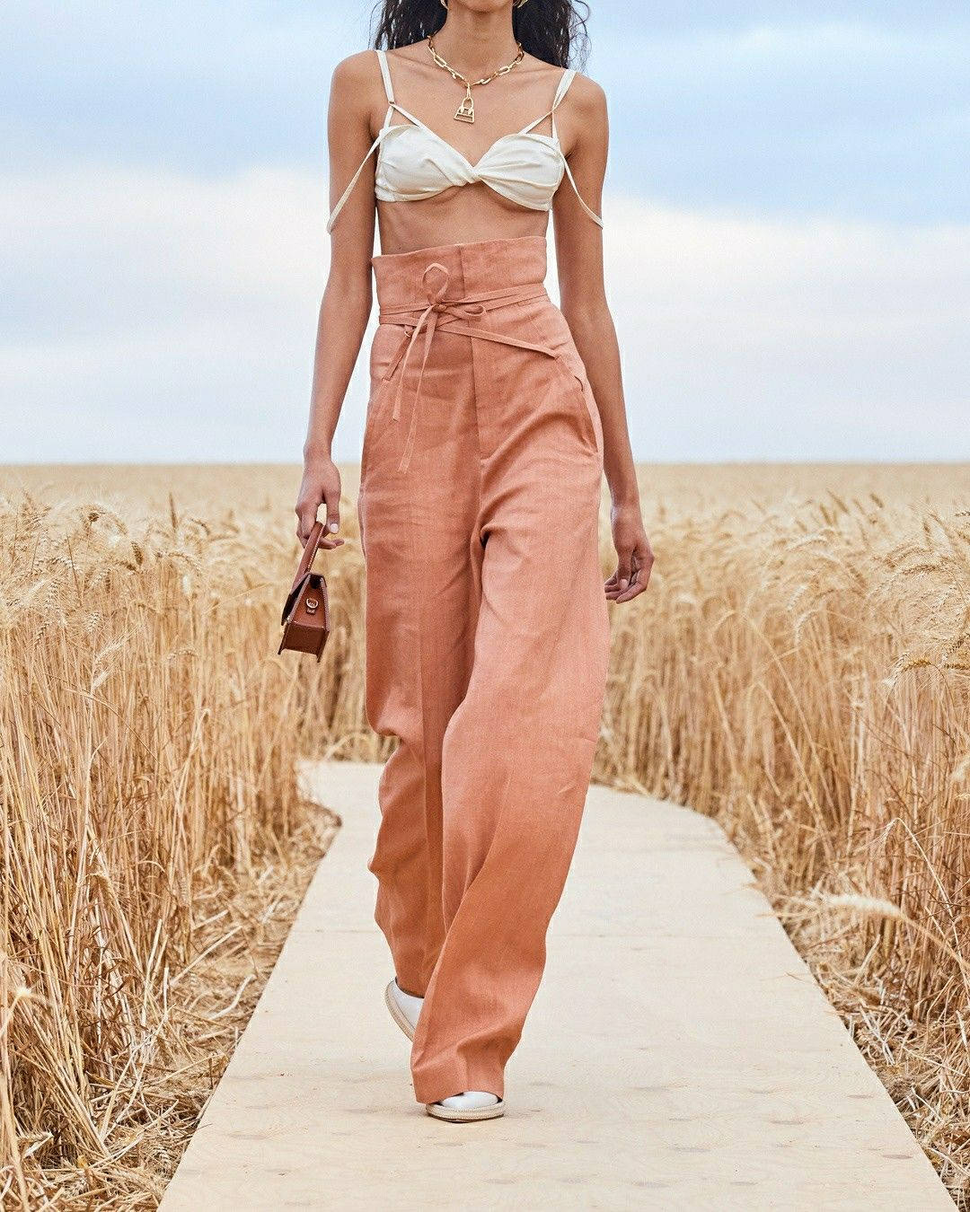 Caption: Elegant Fashion With Jacquemus - Model In Top And Pants Wallpaper