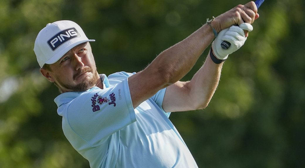 Caption: Mackenzie Hughes Focusing On His Swing On The Golf Course Wallpaper