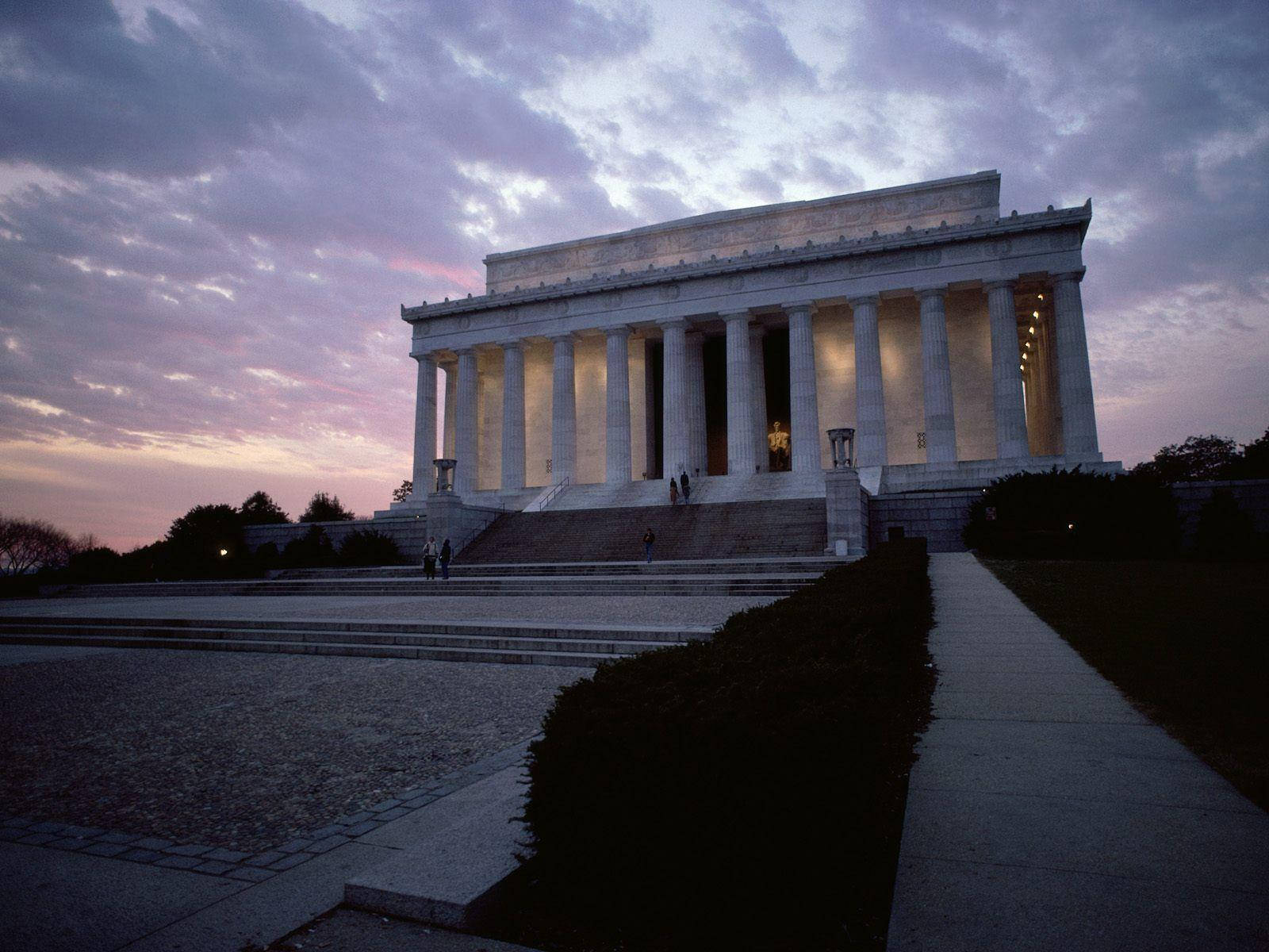 Caption: Majestic View Of Lincoln Monument Under Cloudy Sky Wallpaper