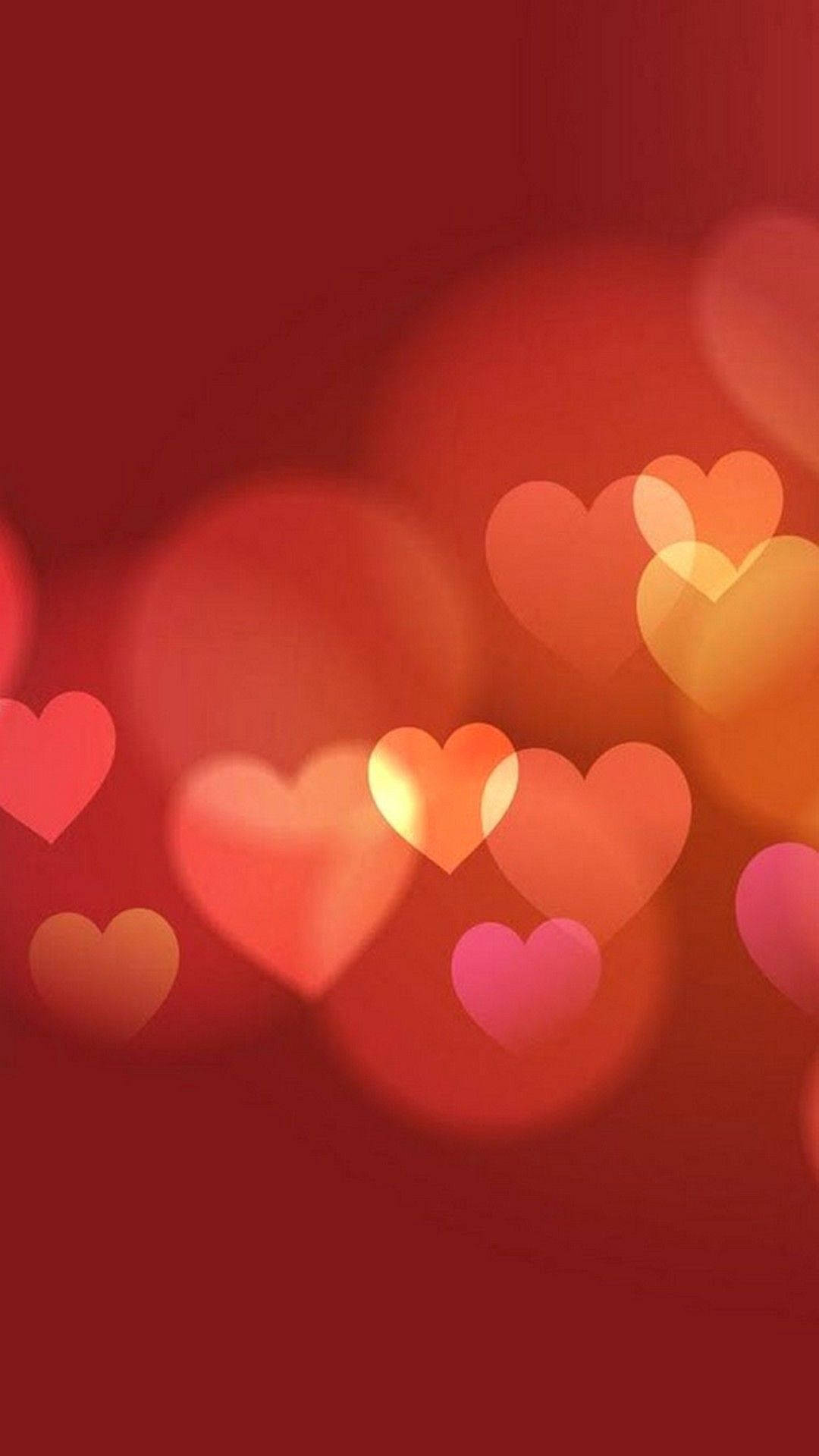 Caption: Radiant Heart On A Red Background For Iphone Display Wallpaper