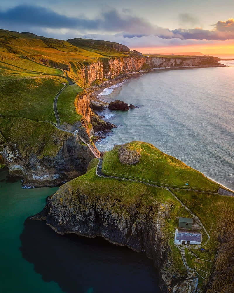 Caption: Scenic View Of Carrick-a-rede Rope Bridge In Northern Ireland Wallpaper