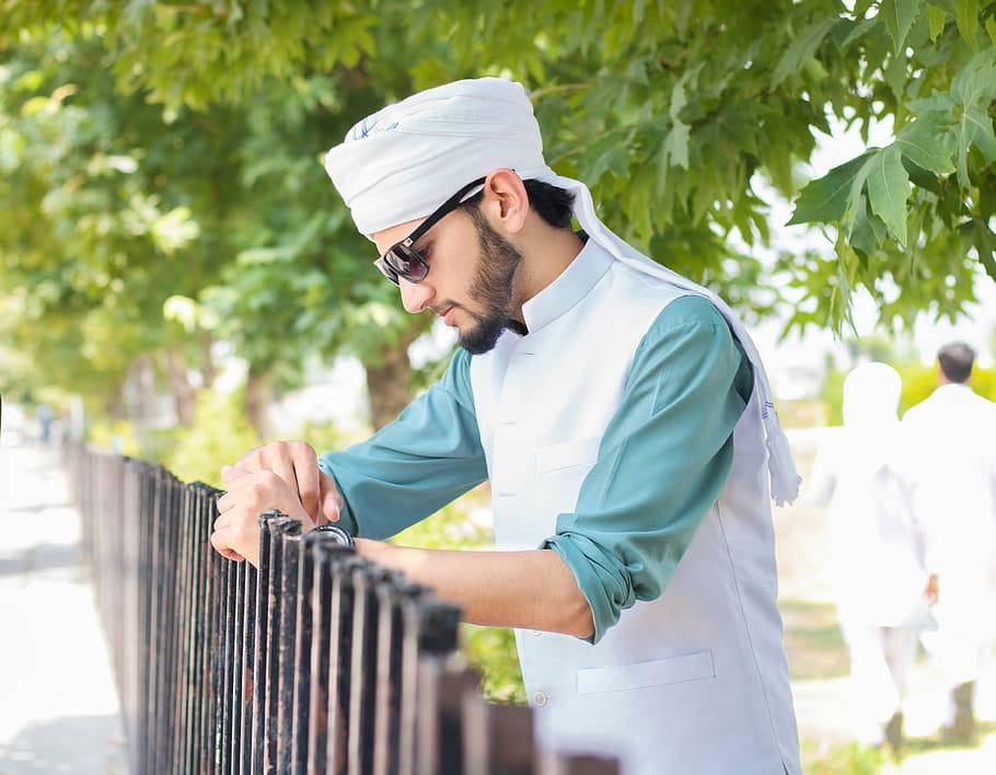 Caption: Stylish Islamic Boy Posing For A Photoshoot Wallpaper
