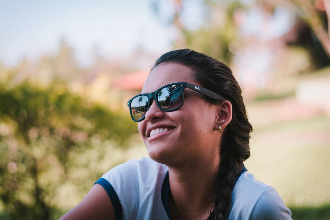 Caption: Stylish Woman In Classic Ray-ban Eyewear Wallpaper